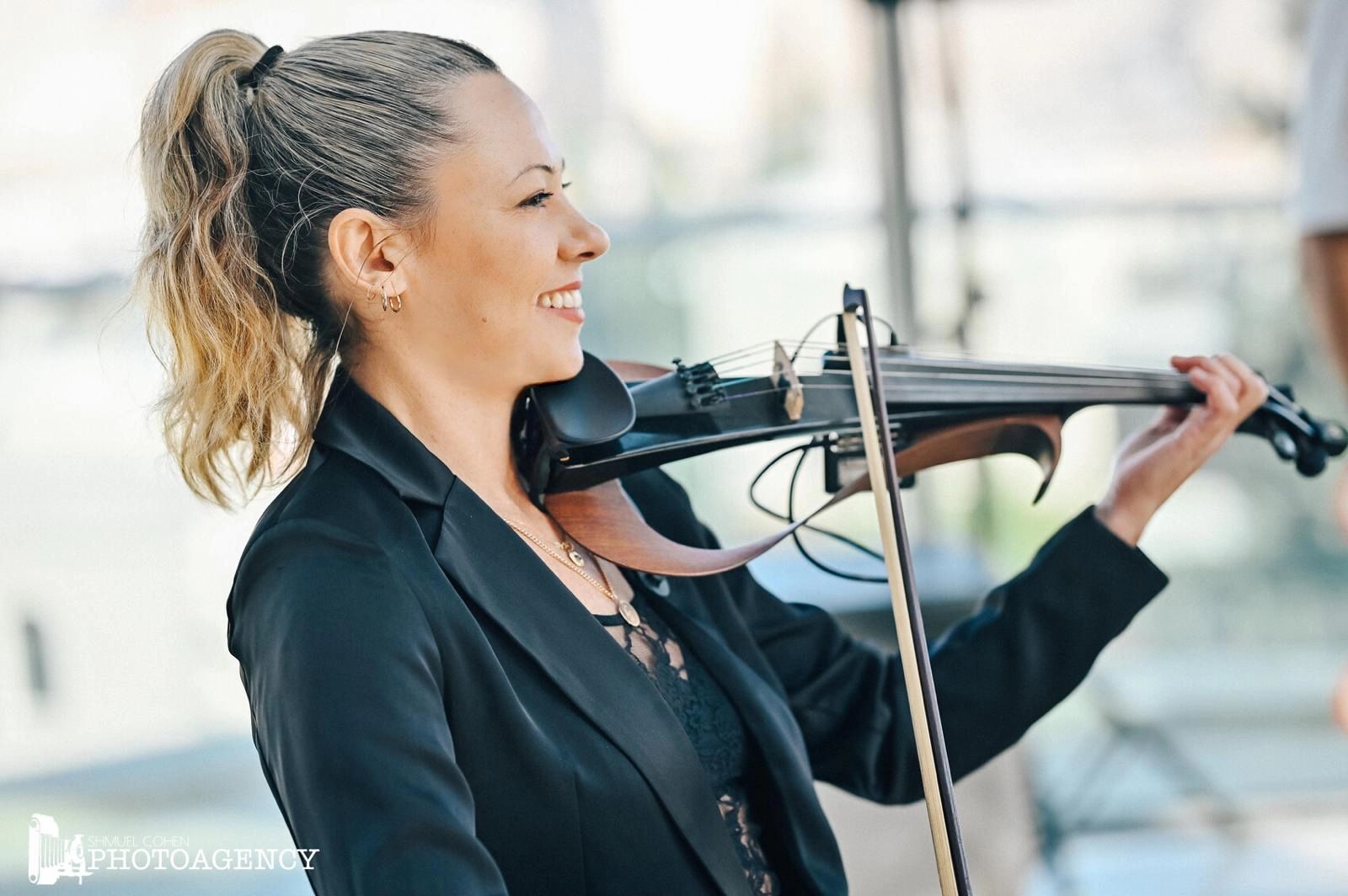 Violinist performing at an outdoor ceremony
